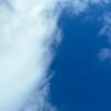 Bright blue sky with fluffy white clouds creating a tranquil atmosphere.